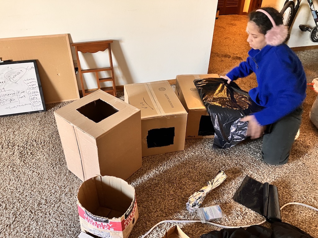 Building the first cardboard shelters by hand